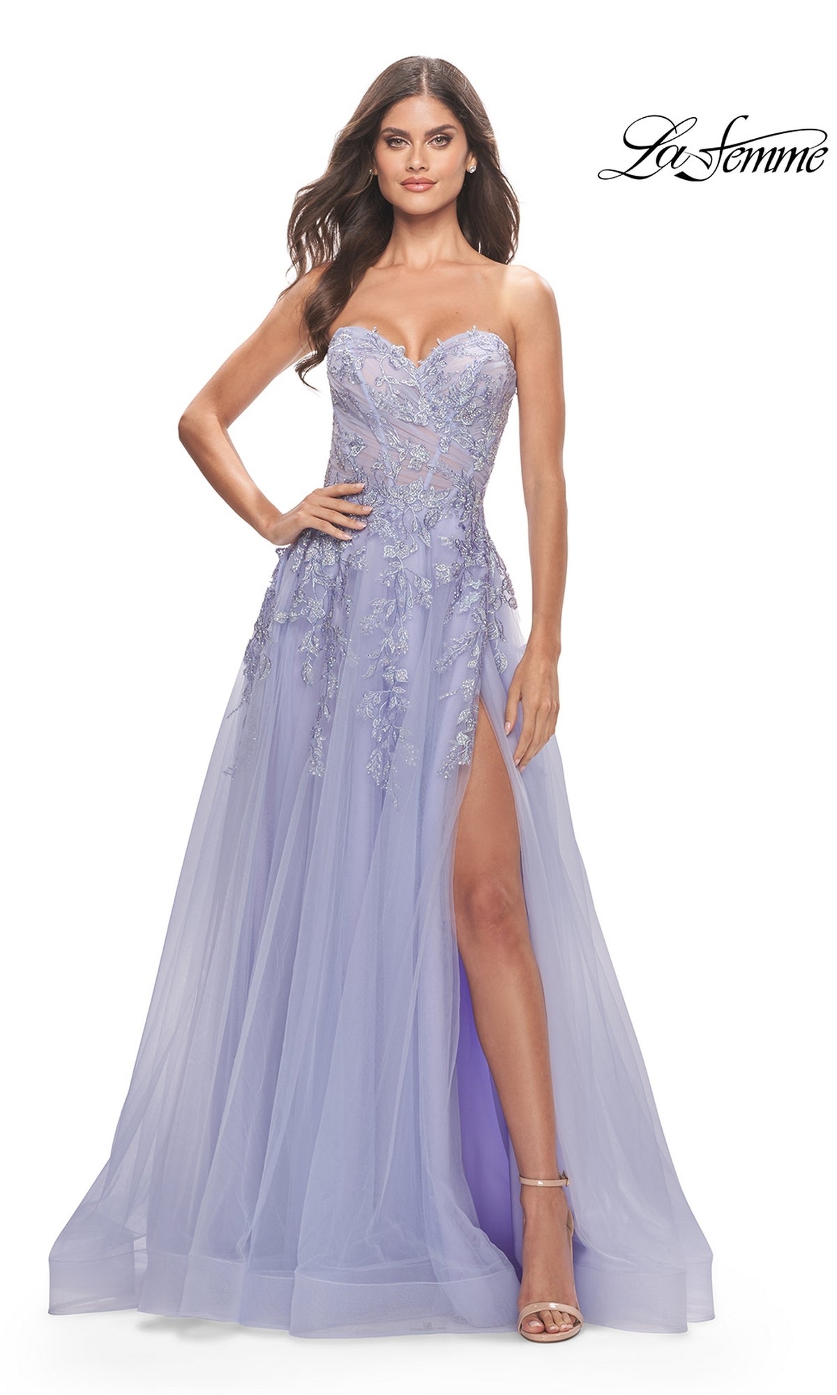 A woman stands confidently with one hand on her hip, wearing the La Femme Strapless Sweetheart Long Prom Dress 31363 in lavender, featuring floral embroidery and a high leg slit.